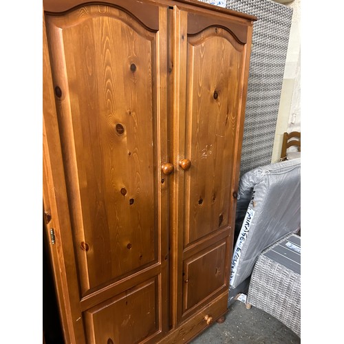 409 - PINE DOUBLE WARDROBE WITH PANELLED DOORS AND DRAWER BELOW