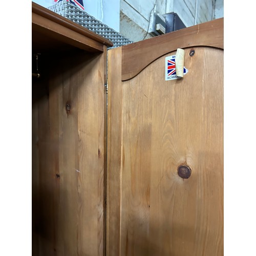 409 - PINE DOUBLE WARDROBE WITH PANELLED DOORS AND DRAWER BELOW