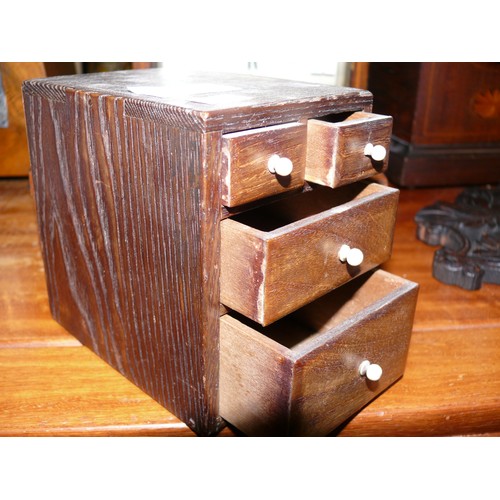 323 - A miniature set of wooden drawers, together with a mahogany hinged box.