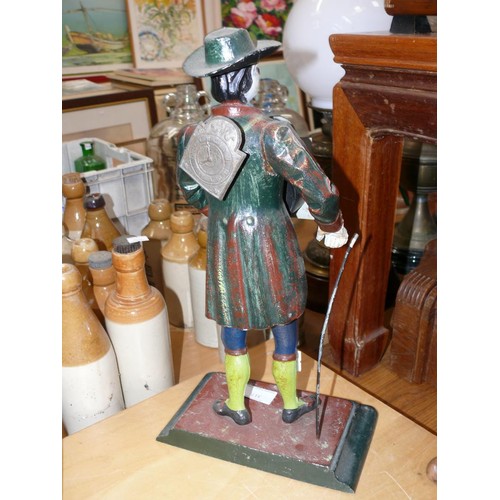 317 - Vintage J.V.E Holland peddlar mantle clock. A cast iron figure of a Dutch clock street seller/peddla... 