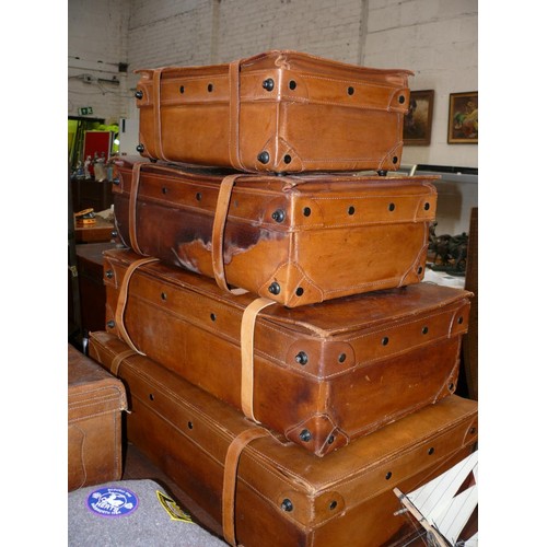 104 - Quality set of four graduating Italian tan leather suitcases by Giovanni, with keys. Some water mark... 