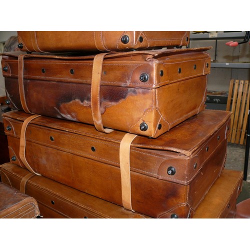 104 - Quality set of four graduating Italian tan leather suitcases by Giovanni, with keys. Some water mark... 