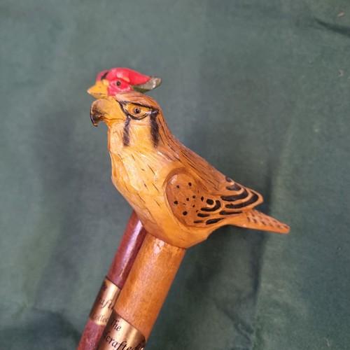 330 - 2x wooden walking sticks with hand carved & painted bird handles. 1x Pheasant & 1x Hawk. Each has a ... 