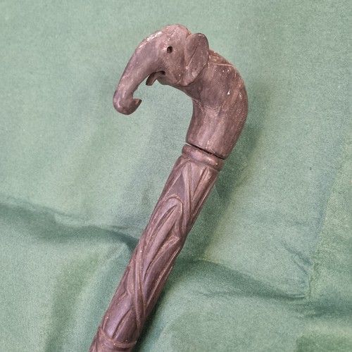 335A - African ebonised walking stick with carved elephants head handle.