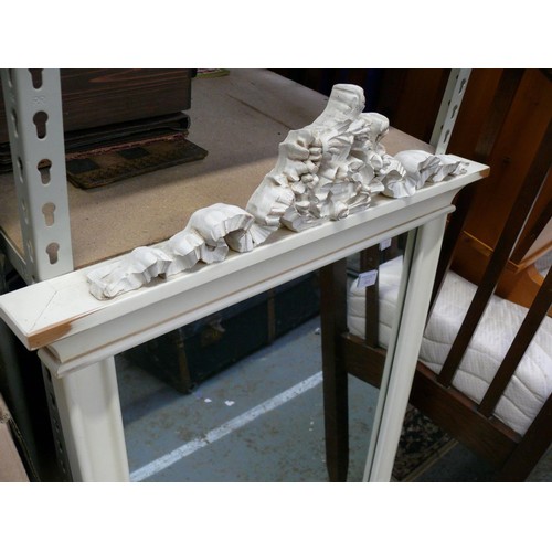 413 - A large over mantel mirror with classical scrolling ribbon cornice. Painted white.