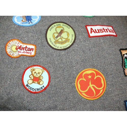 336 - Girl guides felt poncho blanket covered in 1980's guide patches, including a Trefoil Guild ribbon dr... 