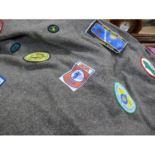 336 - Girl guides felt poncho blanket covered in 1980's guide patches, including a Trefoil Guild ribbon dr... 