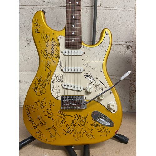 73 - SIGNED Aria STG-series gold flake Stratocaster electric guitar covered in musicians signatures front... 