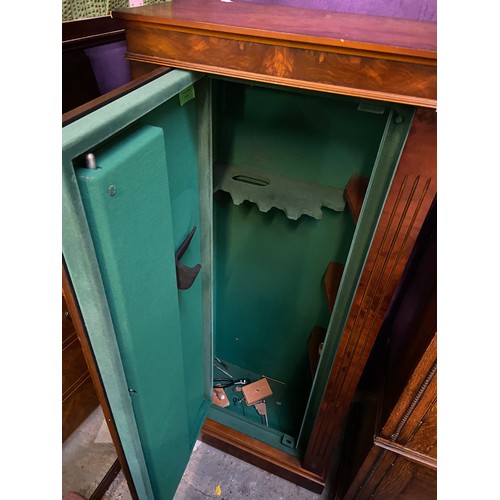 476 - Modern dark walnut veneered incognito gun cabinet in the form of a tallboy chest of drawers.