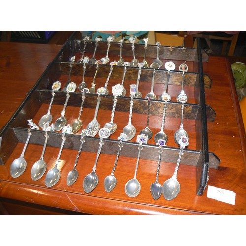 292 - LARGE COLECTION OF MOSTLY CERAMIC THIMBLES WITH DISPLAY CASES PLUS SOUVENIR SPOONS ON A WALL RACK