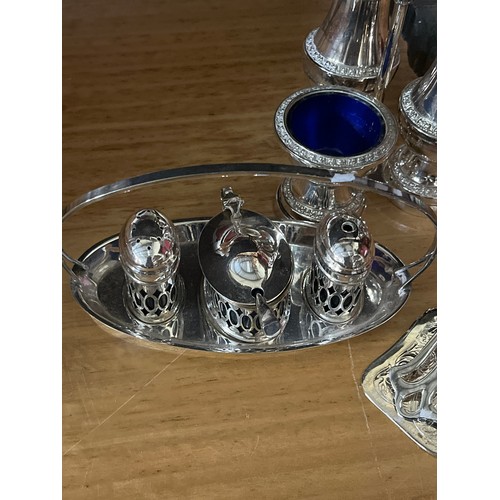 416 - SILVERPLATE CRUET SET AND CONDIMENT SET WITH BLUE GLASS LINERS AND A SET OF SERVING TONGS