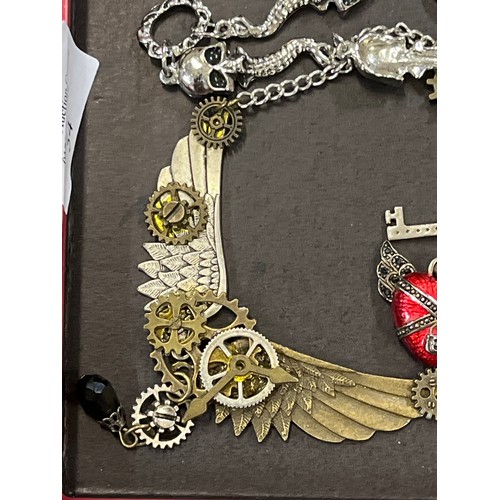 54 - A STEAMPUNK EAGLE WING NECKLACE PLUS SKELETON BRACELET AND WINGED HEART WITH THOMAS SABO SILVER CHAR... 