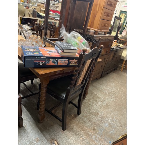 510 - VINTAGE DARK EWOOD EXTENDNG DINING TABLE WITH BOBBIN TURNED LEGS AND A SET OF 4 CHAIRS WITH RATTAN A... 