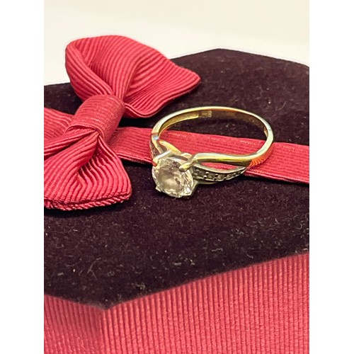 21 - A LOVELY 9CT GOLD ENGAGEMENT RING WITH LARGE WHITE STONE AND STONES ON THE SHANKS SIZE L WEIGHT 1.7g... 