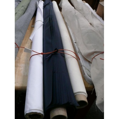 338 - 2 PART ROLLS OF WATERPROOF FABRIC IN WHITE AND CREAM PLUS A ROLL OF OFFCUTS IN NAVY