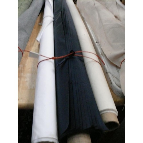 338 - 2 PART ROLLS OF WATERPROOF FABRIC IN WHITE AND CREAM PLUS A ROLL OF OFFCUTS IN NAVY