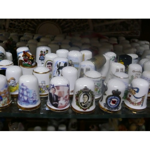 244 - A COLLECTION OF THIMBLES MOSTLY CERAMIC BUT SOME GLASS AND METAL