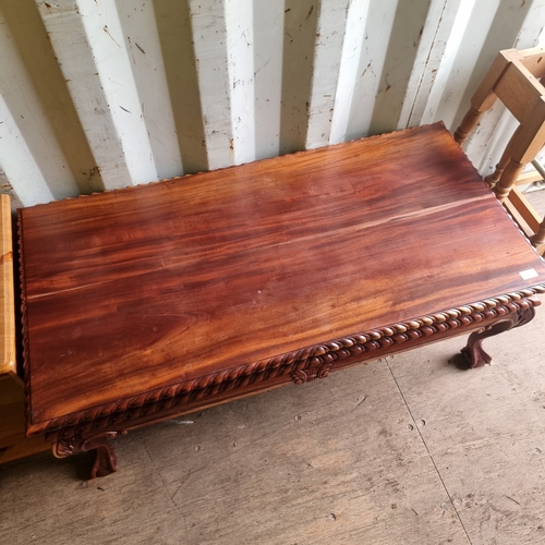 484 - SOLID CLAW FOOTED COFFEE TABLE IN A DARK WOOD FINISH