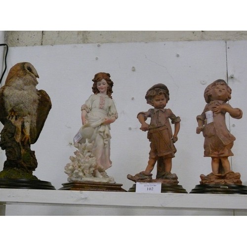 102 - 4 DECORATIVE FIGURINES 1 OWL AND 3 CHILDREN