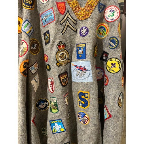 59 - VINTAGE CAMP PONCHO WITH A LARGE COLLECTION OF PATCH BADGES STITCHED ONTO IT, MANY SCOUTING TO INCLU... 