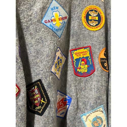 59 - VINTAGE CAMP PONCHO WITH A LARGE COLLECTION OF PATCH BADGES STITCHED ONTO IT, MANY SCOUTING TO INCLU... 