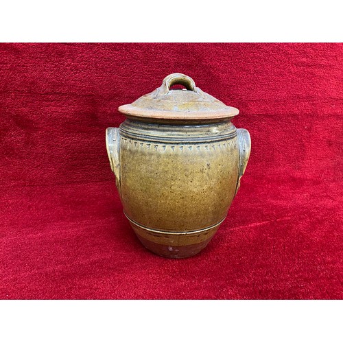 135 - Large earthenware storage jar with brown slip glaze. 35cm tall lidded.for flour or salt