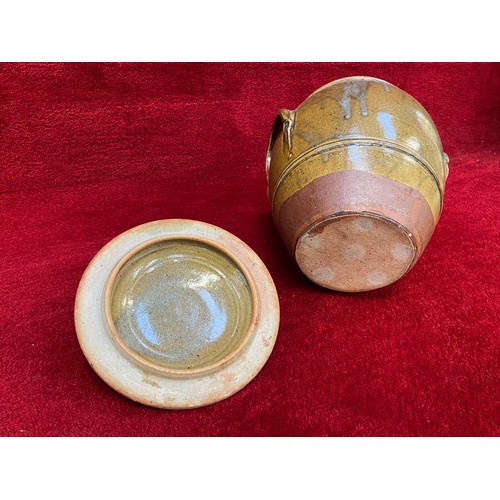 135 - Large earthenware storage jar with brown slip glaze. 35cm tall lidded.for flour or salt