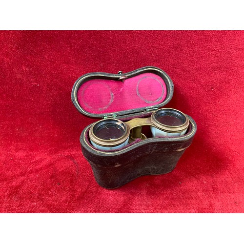 151 - Mother of pearl & brass opera glasses in original leather case.