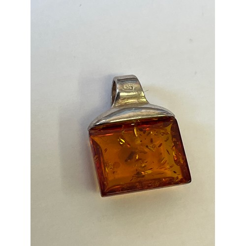 34 - A COLLECTION OF FOUR SOLID SILVER AND BALTIC AMBER PENDANTS