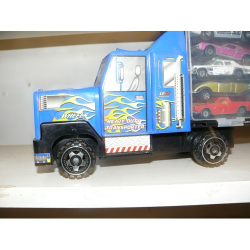 95 - A LARGE LORRY MODEL WITH SIDE STORAGE PANELS WITH APPROXIMATELY 25 MINI DIE CAST MODELS