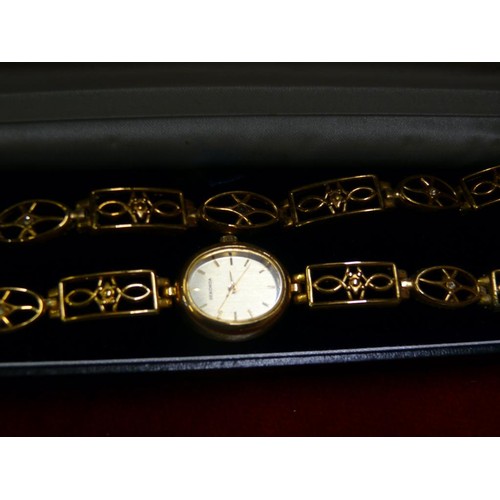 7 - LADIES SEKONDA WRIST WATCH & BRACELET SET - GOLD PLATED. THE STRAP & BRACELET SET WITH DIAMANTE