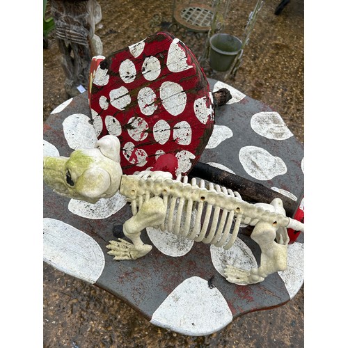 401 - Handmade and painted toadstool table with small toadstools and dog & frog skeletons