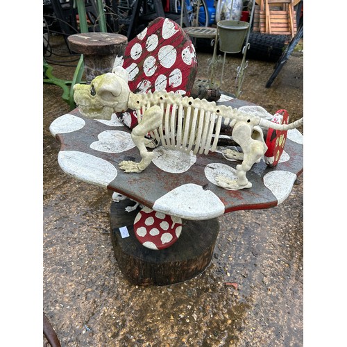 401 - Handmade and painted toadstool table with small toadstools and dog & frog skeletons