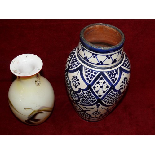 8 - Hand painted blue & white Moroccan pottery vase, together with a swirling Dalian art glass vase.