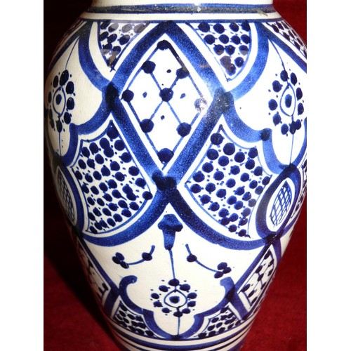 8 - Hand painted blue & white Moroccan pottery vase, together with a swirling Dalian art glass vase.