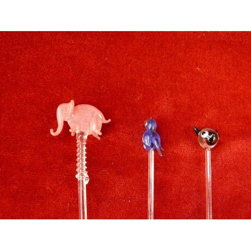 21 - A group of glass cocktail stirrer sticks with animal finials.