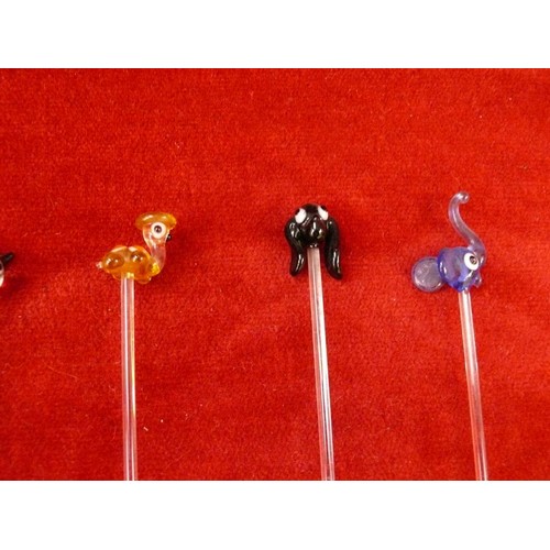 21 - A group of glass cocktail stirrer sticks with animal finials.