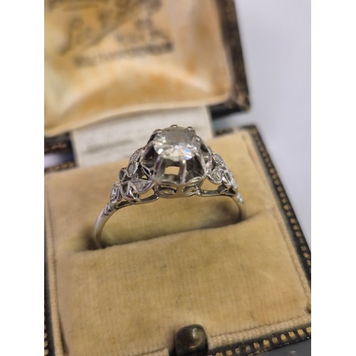 47 - A vintage Art Deco style platinum and diamond dress ring, the central diamond of approximately 0.65c... 