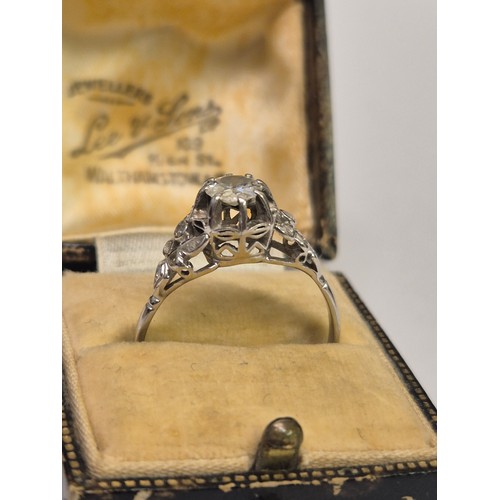 47 - A vintage Art Deco style platinum and diamond dress ring, the central diamond of approximately 0.65c... 