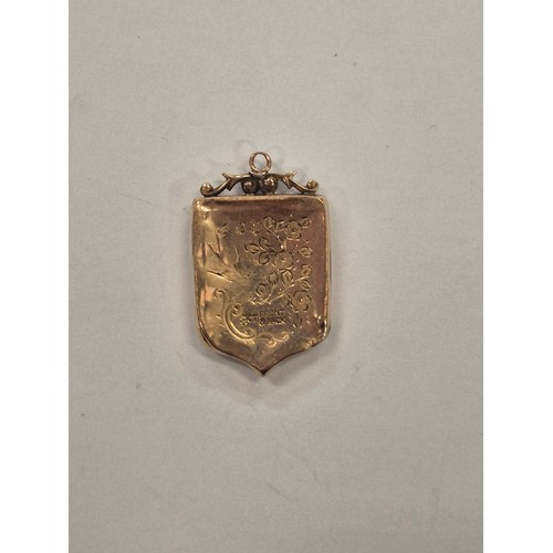 14F - Antique 9ct front & back shield shaped locket. Foliate engraving.