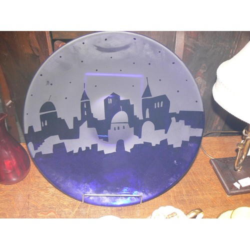 280 - Cobalt blue art glass plate, etched with a middle eastern city skyline. 40.5cm diameter.