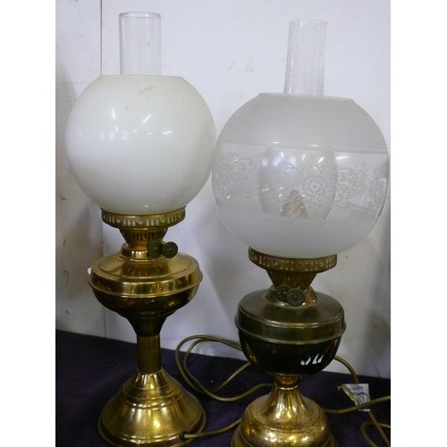 114 - 2 VINTAGE OIL LAMP ELECTRIC LIGHTS WITH BRASS BASES AND GLASS FUNNELS AND GLOBES