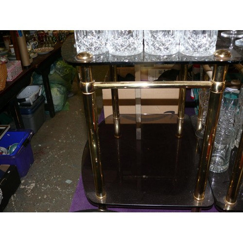 186 - A PAIR OF SMOKEY GLASS SIDE TABLES WITH BRASS FRAMES