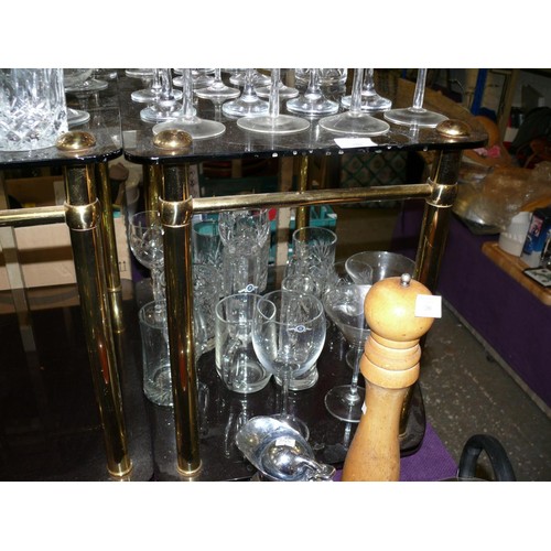 186 - A PAIR OF SMOKEY GLASS SIDE TABLES WITH BRASS FRAMES