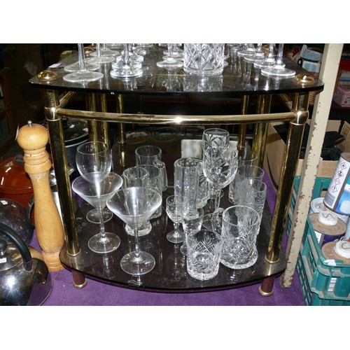 186 - A PAIR OF SMOKEY GLASS SIDE TABLES WITH BRASS FRAMES