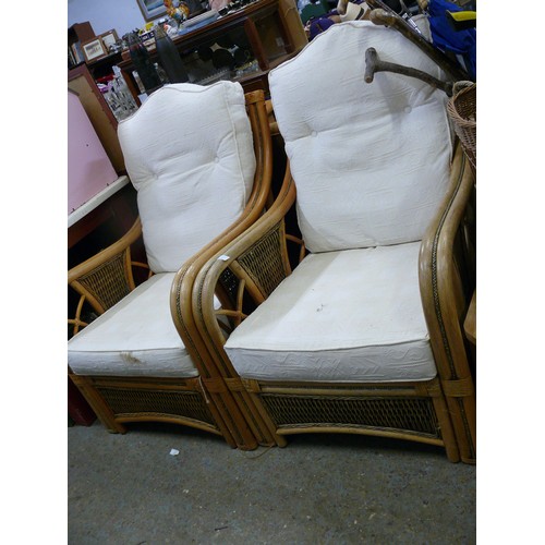 341 - PAIR OF CANE CONSERVATORY ARMCHAIRS WITH CREAM CUSHIONS