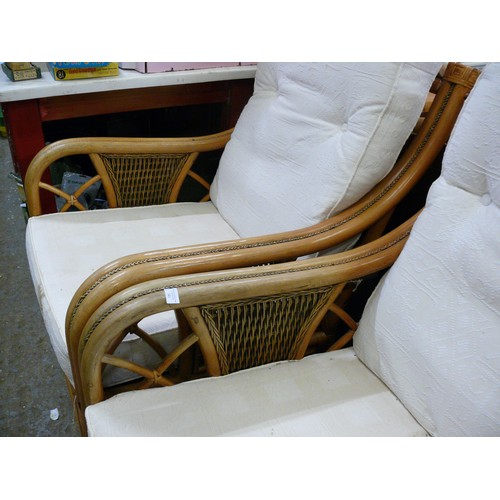 341 - PAIR OF CANE CONSERVATORY ARMCHAIRS WITH CREAM CUSHIONS