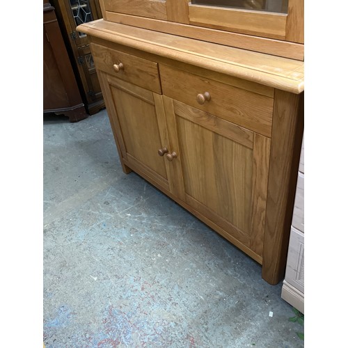 467 - LARGE LIGHT OAK DISPLAY CABINET WITH GLAZED DOORS TO TOP AND CUPBOARD PLUS 2 DRAWERS BELOW