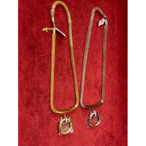 44 - TWO BRAND NEW ROPE NECKLACES WITH RING PENDANTS, ONE IN ROSE GOLD COLOUR THE OTHER YELLOW GOLD