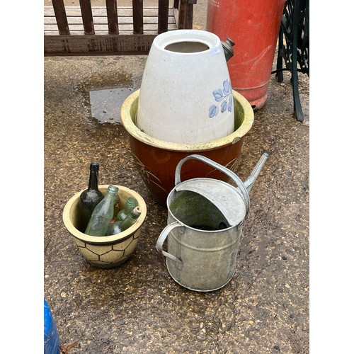 535 - LARGE STONEWARE PLANTERS, GLASS BOTTLES AND A GALVANISED WATERING CAN